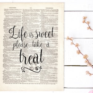 May include: A vintage dictionary page with the text "Life is sweet, please take a treat" written in black cursive script. The text is surrounded by small illustrations of fruit and leaves.