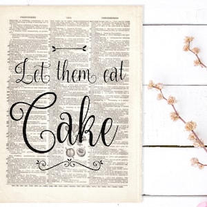 May include: Black and white typography print with the text "Let them eat cake" on a vintage dictionary page background.