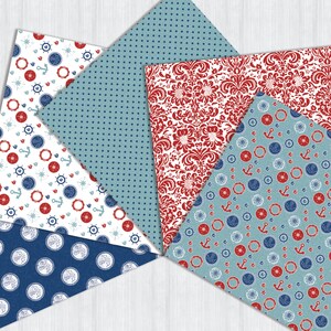 May include: Five different patterned scrapbook papers in red, white, and blue. The patterns include nautical anchors, compasses, and polka dots.
