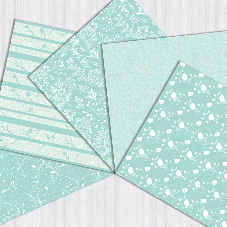May include: Six different patterned papers in shades of light blue and white. The patterns include stripes, floral designs, and birds.