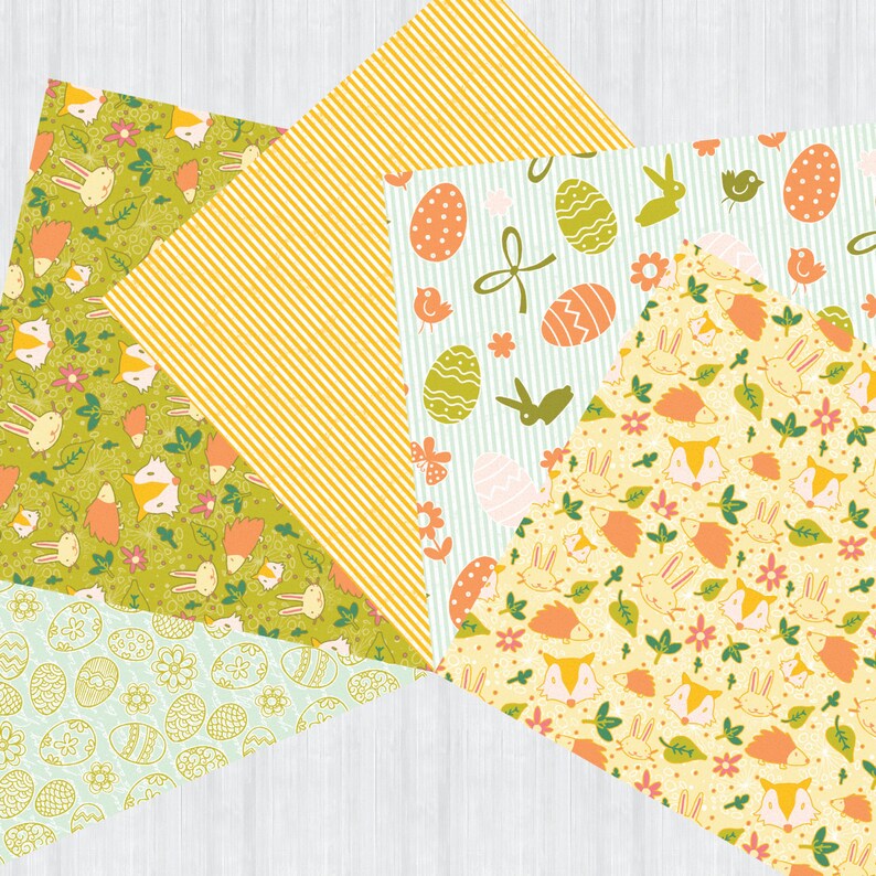 May include: Four different patterned scrapbook papers featuring Easter themes. The papers are yellow, green, and blue with various patterns including bunnies, eggs, and flowers.
