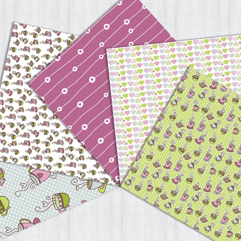 May include: A collection of patterned papers featuring various designs. Patterns include pink stripes with white circles, hearts in pink and green, and teacups on a green striped background. The papers are arranged on a white wooden surface.