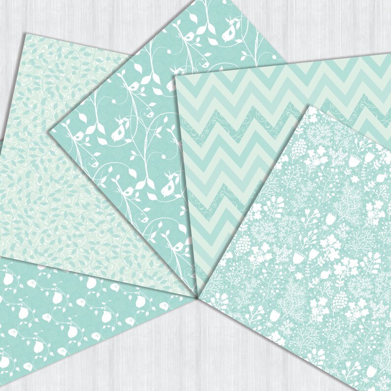 May include: Five different patterned papers in shades of light blue and white. The patterns include a floral design, a chevron pattern, and a small leaf pattern.