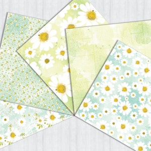 May include: Five different patterned papers with a watercolor background and white daisies. The papers are in a fan shape and have a light green, blue, and white color scheme.