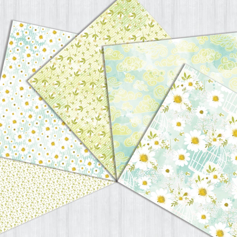 May include: Five different patterned papers with a green and white color scheme. The patterns include small white flowers, green leaves, white clouds on a blue background, and large white flowers on a blue background.