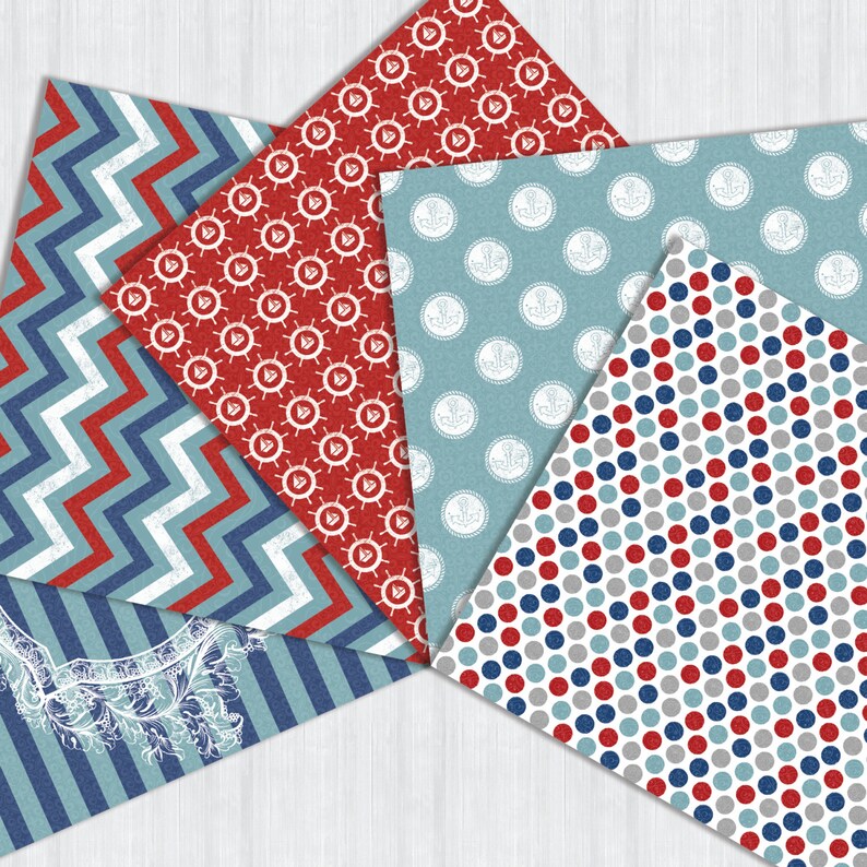 May include: Five different patterned scrapbook papers in red, blue, and gray. The patterns include anchors, polka dots, stripes, and zigzags.