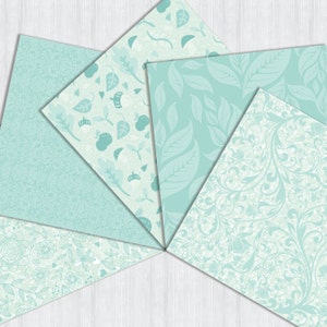 May include: Six different patterned scrapbook paper sheets in various shades of light blue and white. The patterns include leaves, flowers, and swirls.