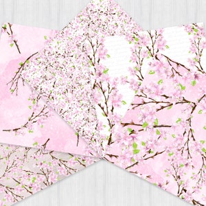 Puede incluir: Cuatro papeles estampados diferentes, rosa y blanco, con un dise&ntilde;o floral que presenta flores de cerezo rosas y hojas verdes. Los papeles est&aacute;n dispuestos en forma de estrella.