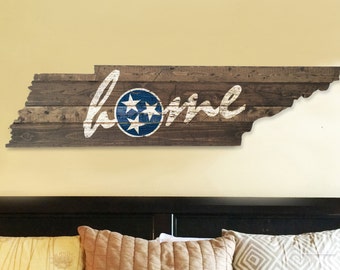 Wooden state of Tennessee cut out with HOME painted and distressed on it!