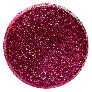 May include: A round, flat, pink glitter disc. The glitter is a mix of pink, red, and iridescent colors.