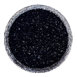 May include: A jar of black glitter. The glitter is fine and has a slight iridescent sheen.