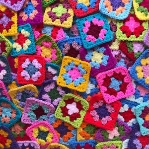 May include: A collection of colorful crocheted squares in various patterns and colors, including red, blue, green, yellow, and purple.