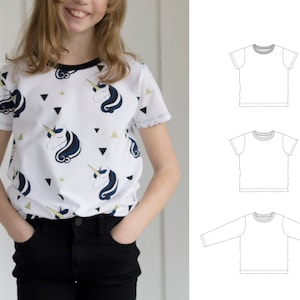 May include: White t-shirt with a black and gold unicorn print. The shirt has short sleeves and a round neckline. Three different t-shirt silhouettes are shown in black and white.