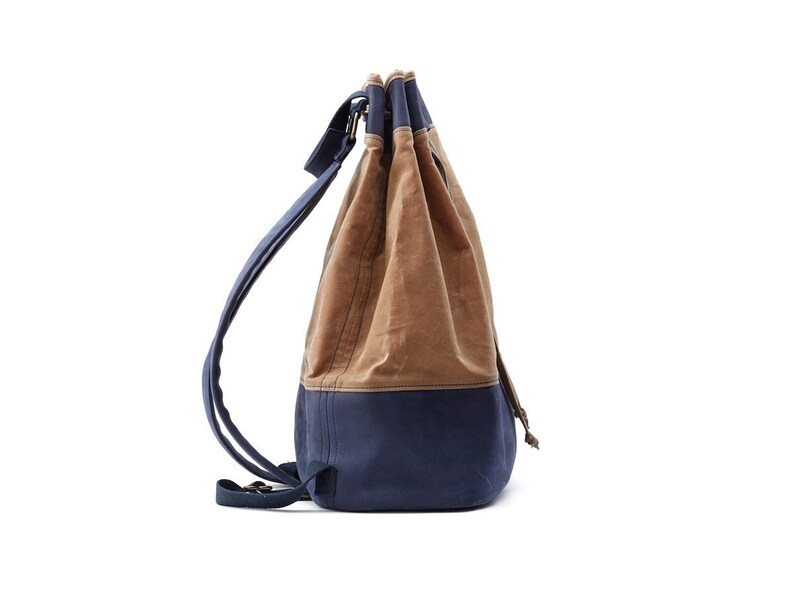May include: A brown and blue canvas drawstring backpack with adjustable straps.