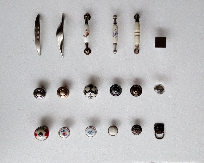 May include: Assortment of cabinet hardware, including pulls and knobs. The pulls are made of metal and have a variety of finishes, including silver, gold, and black. The knobs are made of ceramic and have a variety of designs, including floral, geometric, and abstract.