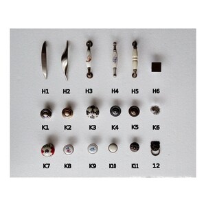 May include: Assortment of cabinet hardware, including pulls and knobs. The pulls are made of metal and have a variety of finishes, including silver, gold, and black. The knobs are made of ceramic and have a variety of designs, including floral, geometric, and abstract.