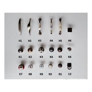 May include: Assortment of cabinet hardware, including pulls and knobs. The pulls are made of metal and have a variety of finishes, including silver, gold, and black. The knobs are made of ceramic and have a variety of designs, including floral, geometric, and abstract.