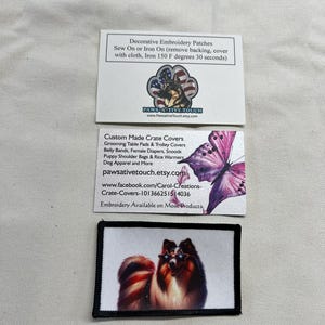 May include: A rectangular embroidered patch featuring a long-haired dog wearing star-shaped sunglasses with red, white, and blue patterns. The patch is displayed alongside two white informational cards with text and graphics about custom pet products.