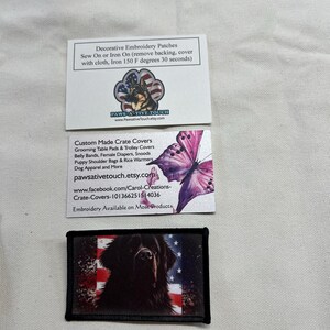 May include: Two rectangular white business cards and one rectangular embroidered patch. The top card features a German Shepherd in a paw print with American flag colors. The middle card shows a pink butterfly. The patch displays a black dog on a flag background.