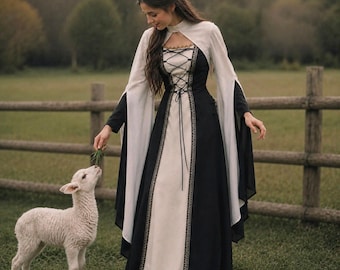 May include: A floor-length dress featuring a black bodice and skirt with a cream-coloured centre panel. The garment has long, flowing cream sleeves, a high neckline, and a black lace-up corset-style front closure with decorative trim.