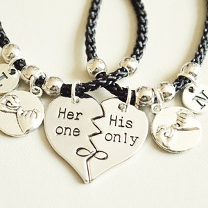 May include: Matching friendship bracelets with black braided cords and silver-tone charms. One bracelet features a split heart with "Her one, His only" text. Additional charms include the letters "L" and "N".