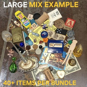 May include: A collection of vintage items including a yellow toy car, a Zippo lighter, coins, a belt buckle, and various small objects. The image includes the text "LARGE MIX EXAMPLE" and "40+ ITEMS PER BUNDLE".
