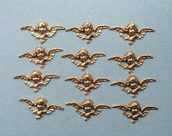 Medium winged angel face antique gold stamping with hollow back. Made in USA, 48 x 24mm, Qty. 12 CC55
