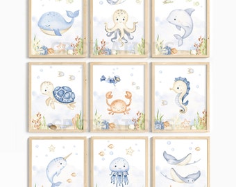 May include: Nine watercolor illustrations of sea creatures in frames. The illustrations include a whale, octopus, dolphin, turtle, crab, seahorse, narwhal, jellyfish, and two stingrays. The illustrations are on a white background with blue bubbles and coral.