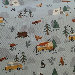 May include: A blue and white fabric with a repeating pattern of camping scenes. The pattern includes tents, campers, trees, bears, and squirrels.
