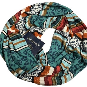 May include: A teal, orange, white, and red striped infinity scarf with a leopard print pattern. The scarf has a pocket that holds a blue passport with the word "PASSPORT" printed on it.