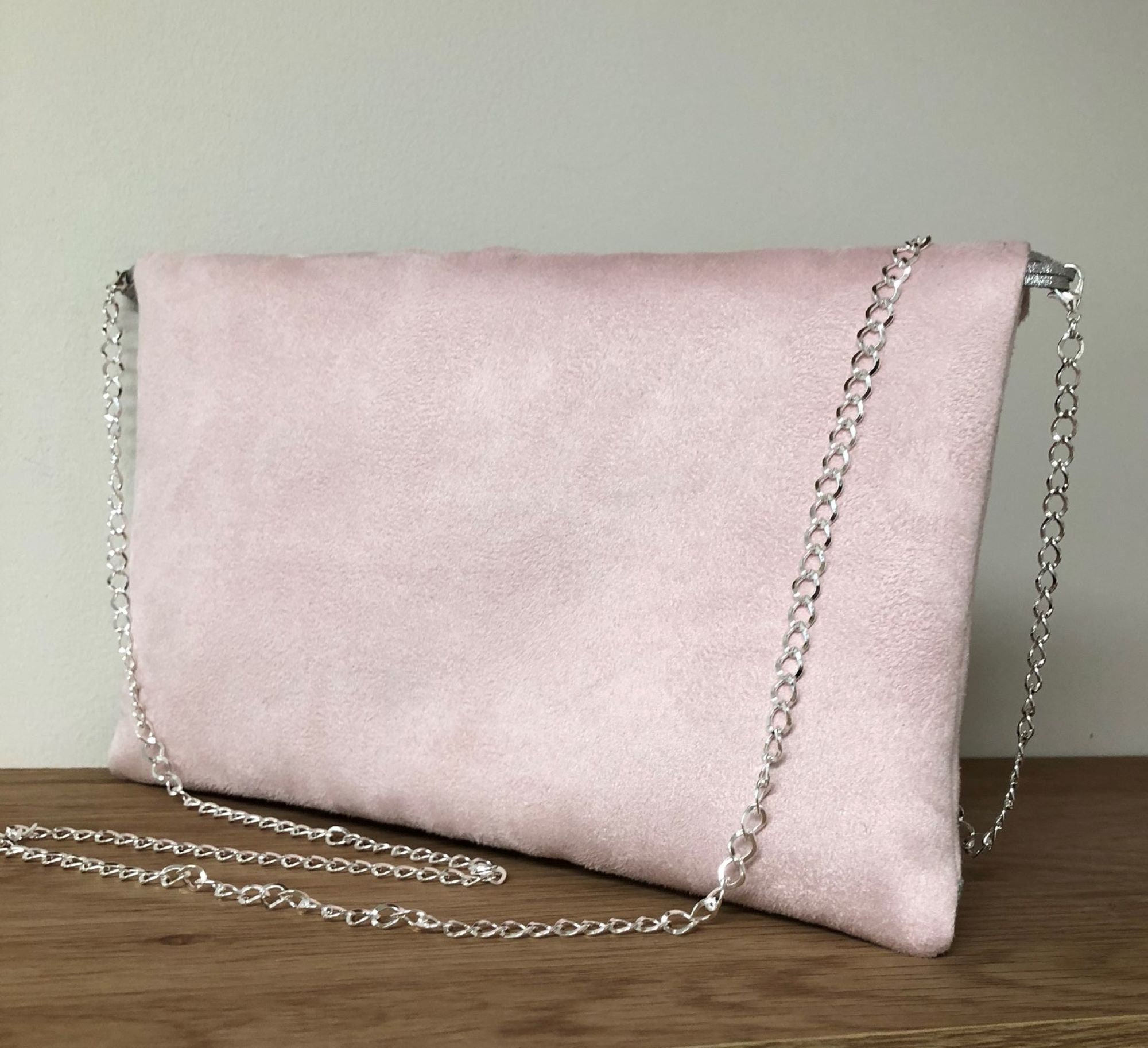 Pale pink suede clutch bag discount