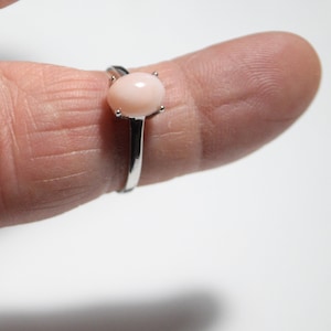 May include: A set of three ceramic mugs with a speckled, matte finish. The mugs are in shades of cream, light gray, and dark gray. Each mug has a simple, minimalist design and a rounded handle.