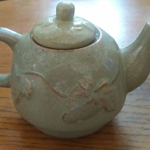 Teapot with a Fruit Vine Encircling it.
