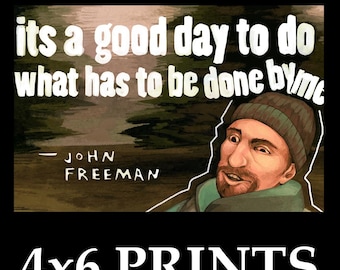 May include: A rectangular print with the text "its a good day to do what has to be done by me" and "- JOHN FREEMAN". The print features an illustration of a man wearing a beanie. The bottom of the print reads "4x6 PRINTS".