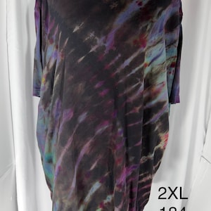 May include: A black tie-dye t-shirt with a crew neck. The shirt features a blend of colors including purple, blue, and green. The size is 2XL, and the number 184 is printed on the shirt.