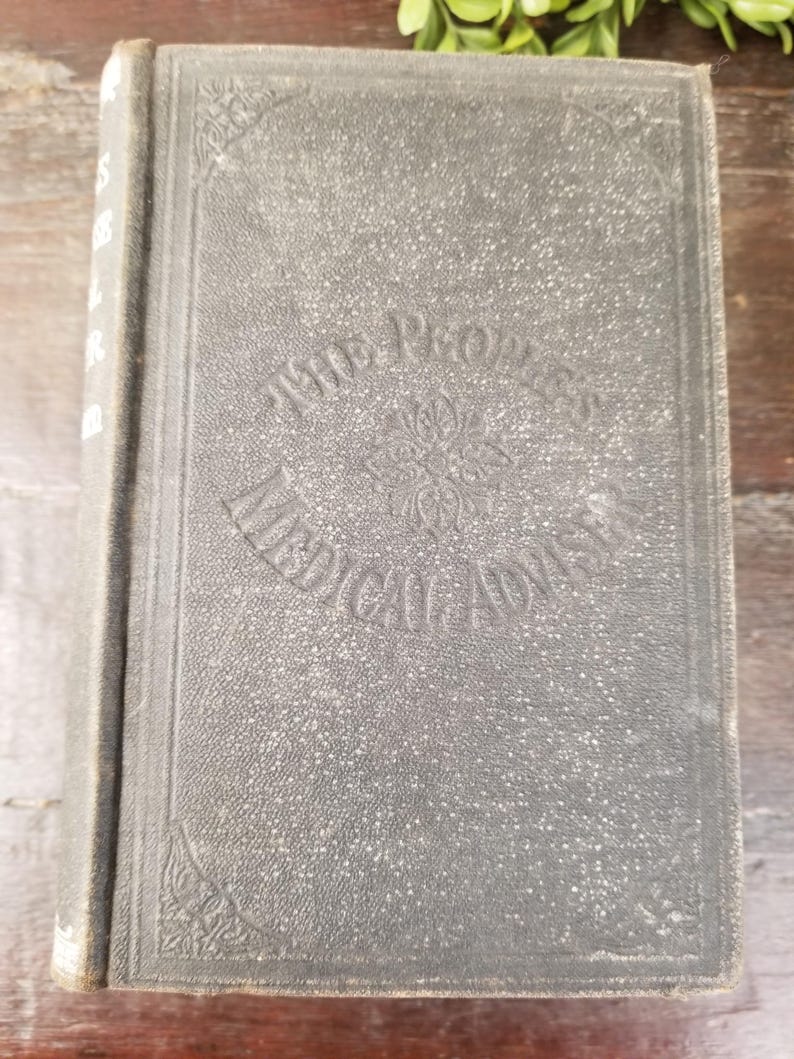 May include: A black hardcover book with the title "The Progress of Liberal Ideas" embossed on the front cover.