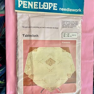 May include: A cream-coloured linen tablecloth with an embroidered floral design. The package includes all the materials needed to complete the embroidery project, including the fabric, thread, needle, and instructions. The tablecloth measures 86 cm by 86 cm.