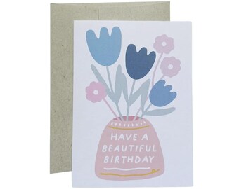 May include: A birthday card with a pink vase with blue and pink flowers and the text "Have a beautiful birthday".
