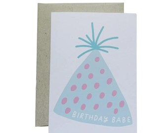May include: A white card with a blue and pink party hat with pink polka dots and the text "Birthday Babe".