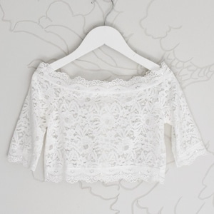 Light ivory lace top with sleeves. Flower girl bolero with artificial pearl buttons
