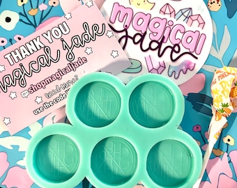 May include: A turquoise silicone mold shaped like a cloud with six circular depressions. The mold is on a floral patterned background with a sticker that says "Magical Jade" and a thank you card.