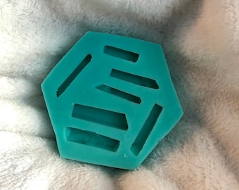 May include: A teal blue hexagonal silicone mold with multiple rectangular cutouts. The mold is designed for making resin crafts.