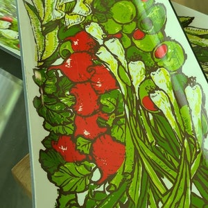 May include: A white ceramic rectangular serving dish with a colorful illustration of various vegetables, including red radishes, green onions, and green leafy vegetables.