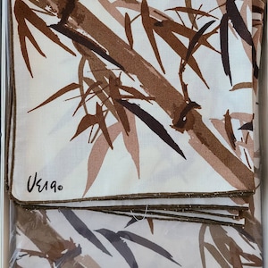 May include: A set of six white cotton napkins with a brown and black bamboo print. The napkins are packaged in a white box with a label that reads "Vera Press, No Iron, Screen Printed, All Cotton, Style 60302, Size 52x70".