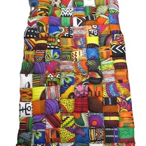 May include: A rectangular patchwork quilt composed of numerous fabric squares in a variety of colors and patterns. The quilt features a vibrant mix of African-inspired prints, including geometric shapes, stripes, and floral designs. The quilt is approximately 40 inches wide and 60 inches long.