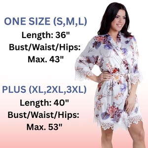 May include: A white satin robe featuring a floral print in shades of purple, orange, and brown, with white lace trim on the sleeves and hem. Text displays sizing: One Size (S, M, L) length 36 inches, max 43 inches; Plus (XL, 2XL, 3XL) length 40 inches, max 53 inches.