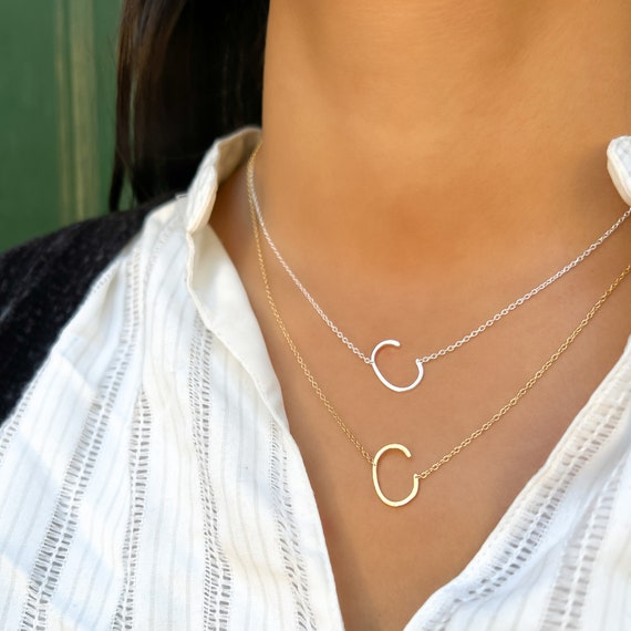 Gold necklace with store letter c