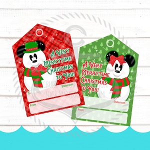 May include: Two rectangular gift tags featuring snowman characters with mouse ears. The red tag has a plaid pattern and green hat, while the green tag has a tree pattern and red bow. Both display the text A Very Merrytime Christmas To You.