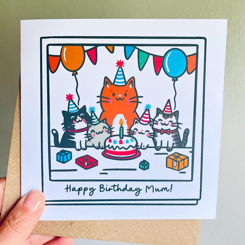 May include: A birthday card featuring a cartoon illustration of six cats wearing party hats, gathered around a cake with a lit candle. The card has the text "Happy Birthday Mum!" and is decorated with balloons and presents.