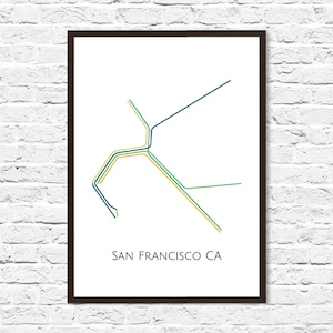 May include: A framed print of a stylized map of San Francisco, California. The map is made up of lines in shades of green, blue, and yellow. The text "SAN FRANCISCO CA" is printed below the map.